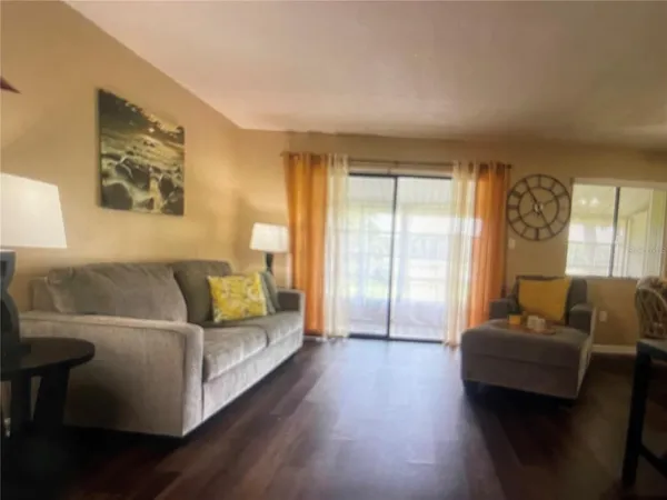 a living room with furniture and a lamp