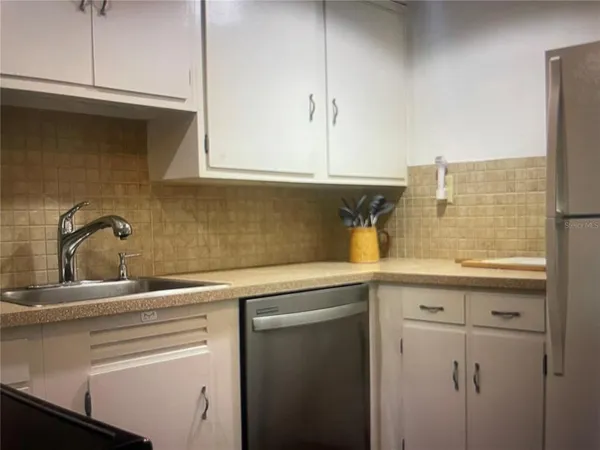 a kitchen with a sink and cabinets