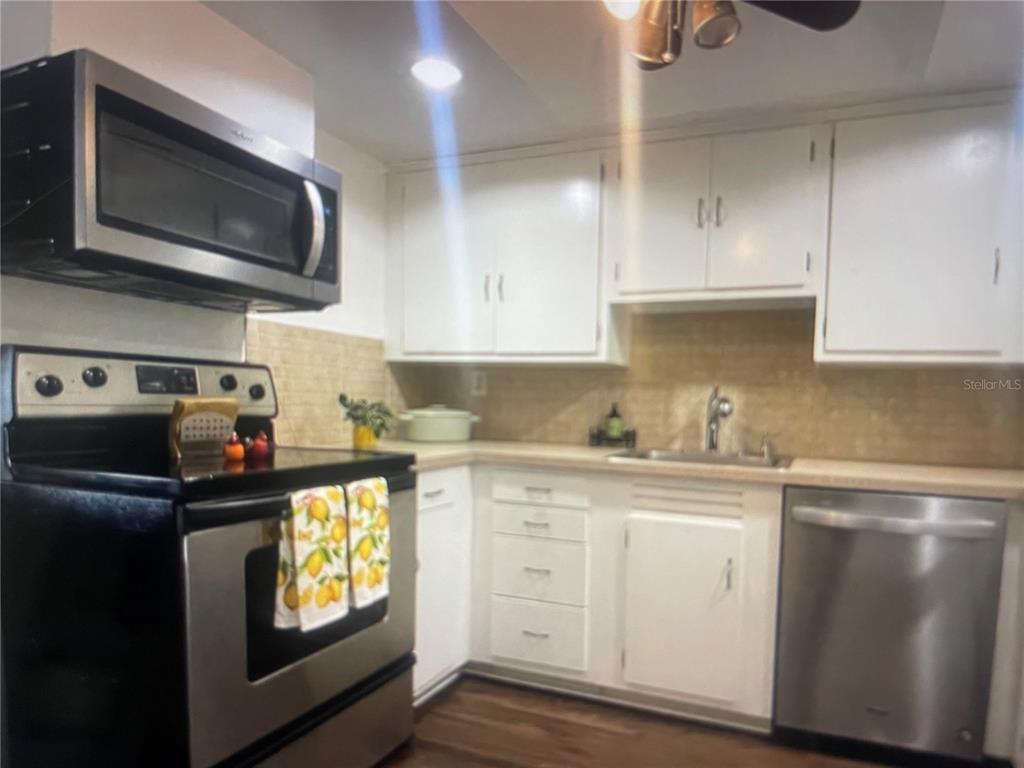 757 Midway Drive, Unit B Ocala, FL 34472 - Photo 17 of 26 a kitchen with a sink and cabinets