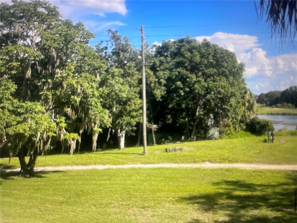 757 Midway Drive, Unit B Ocala, FL 34472 - Photo 23 of 26 a view of a fountain in front of a house with a big yard