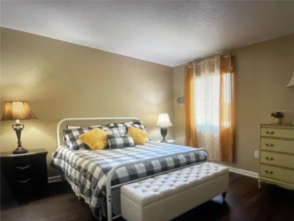 a bedroom with a bed and a lamp