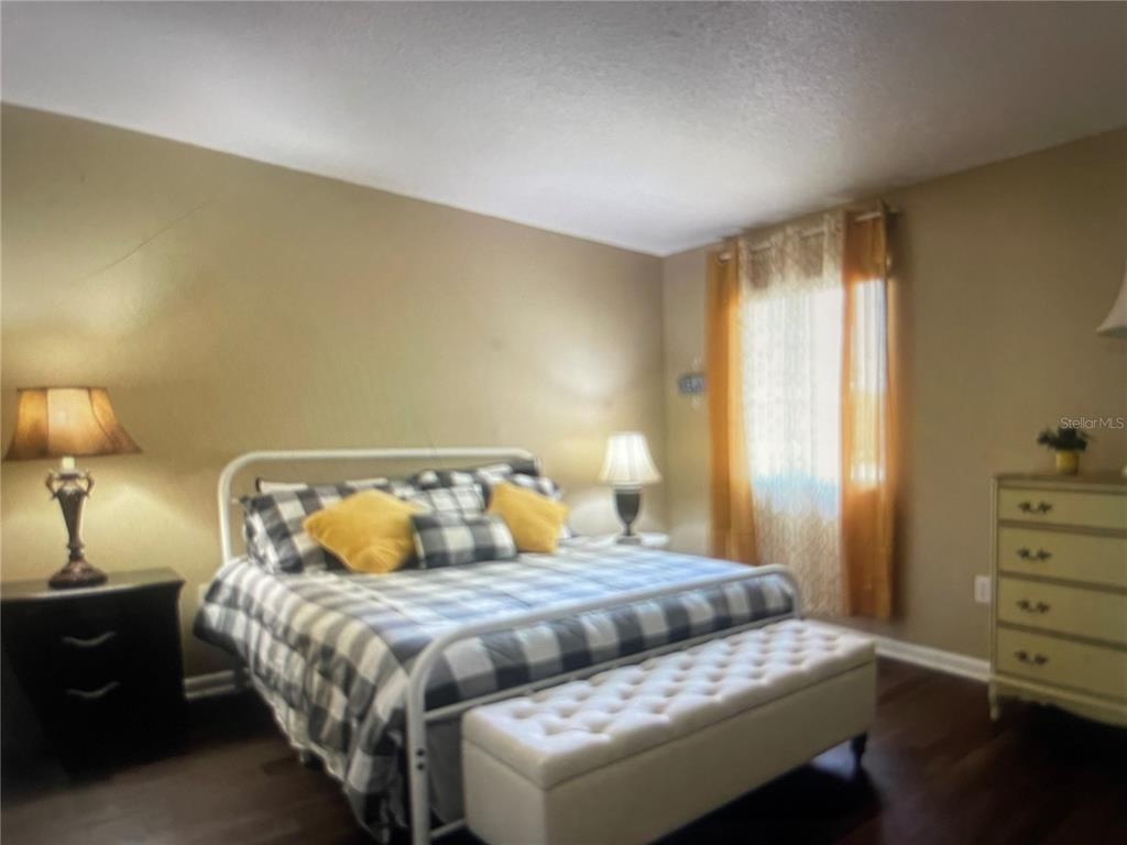 757 Midway Drive, Unit B Ocala, FL 34472 - Photo 5 of 26 a bedroom with a bed and a night stand