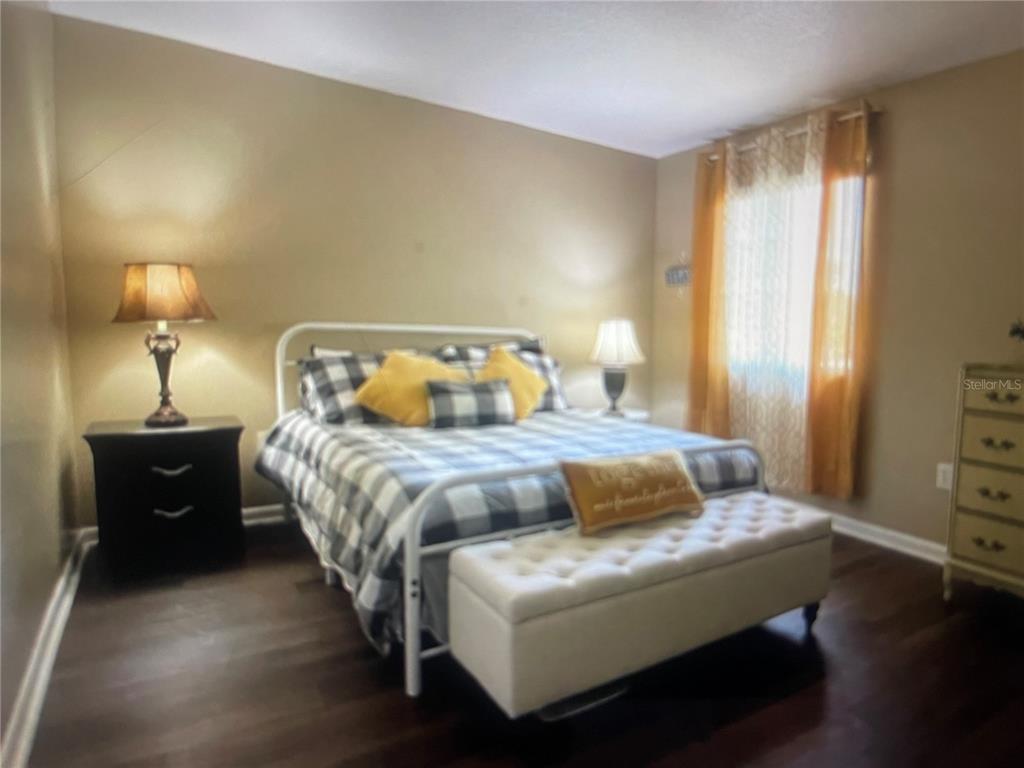 757 Midway Drive, Unit B Ocala, FL 34472 - Photo 6 of 26 a bedroom with a bed and a lamp