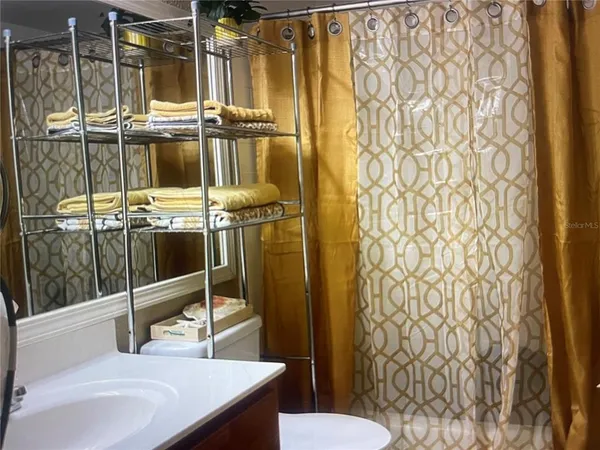 a bathroom with a sink a mirror a vanity and a shower