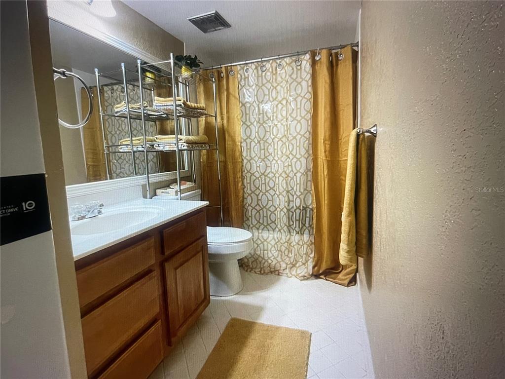 757 Midway Drive, Unit B Ocala, FL 34472 - Photo 9 of 26 a bathroom with a double vanity sink toilet and shower