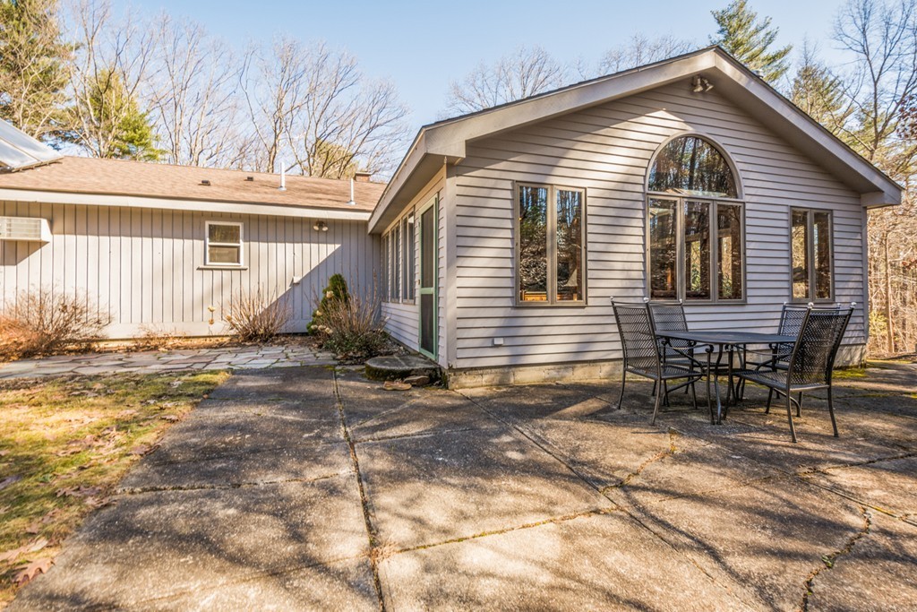 208 Boxboro Road Stow, MA 01775 - Photo 14 of 27 a view of a house with backyard and sitting area