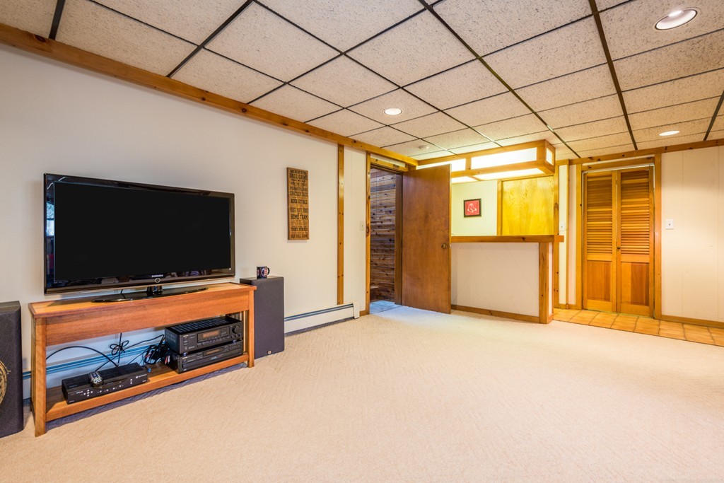 208 Boxboro Road Stow, MA 01775 - Photo 17 of 27 a living room with furniture and a flat screen tv