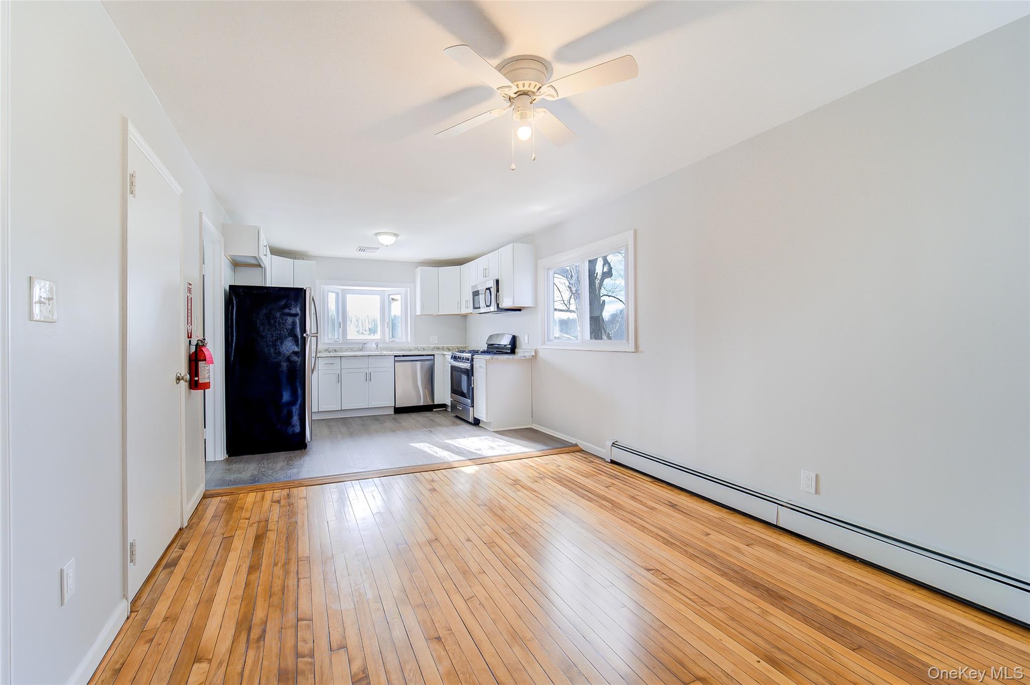 2213 Mt Hope Road, Unit A Middletown, NY 10940 - Photo 11 of 21 a view of kitchen and empty room with wooden floor