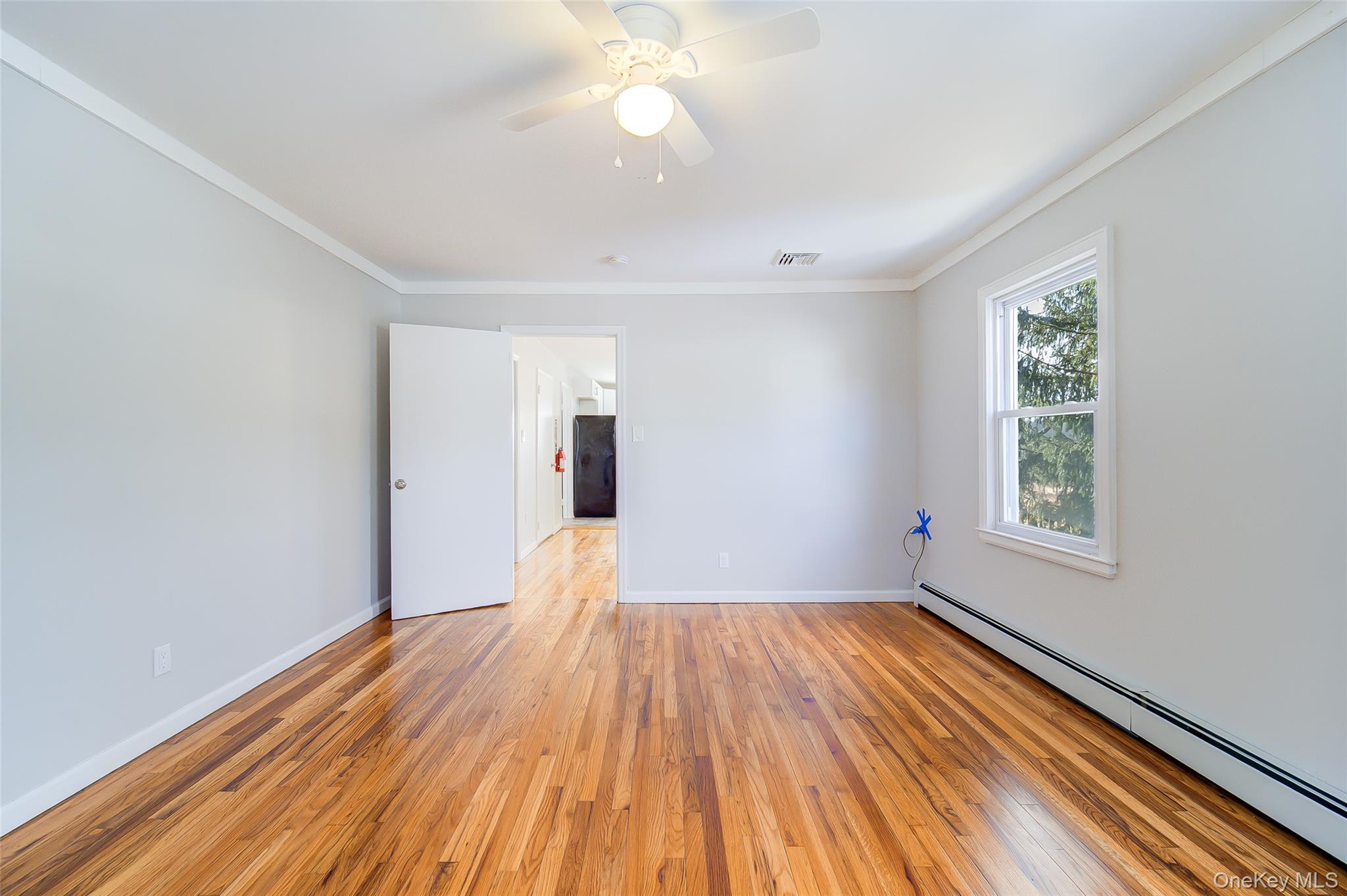 2213 Mt Hope Road, Unit A Middletown, NY 10940 - Photo 20 of 21 a view of empty room with wooden floor and fan