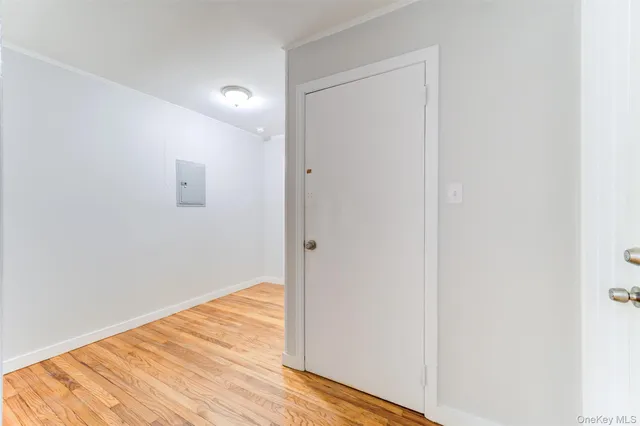a view of a room with wooden floor