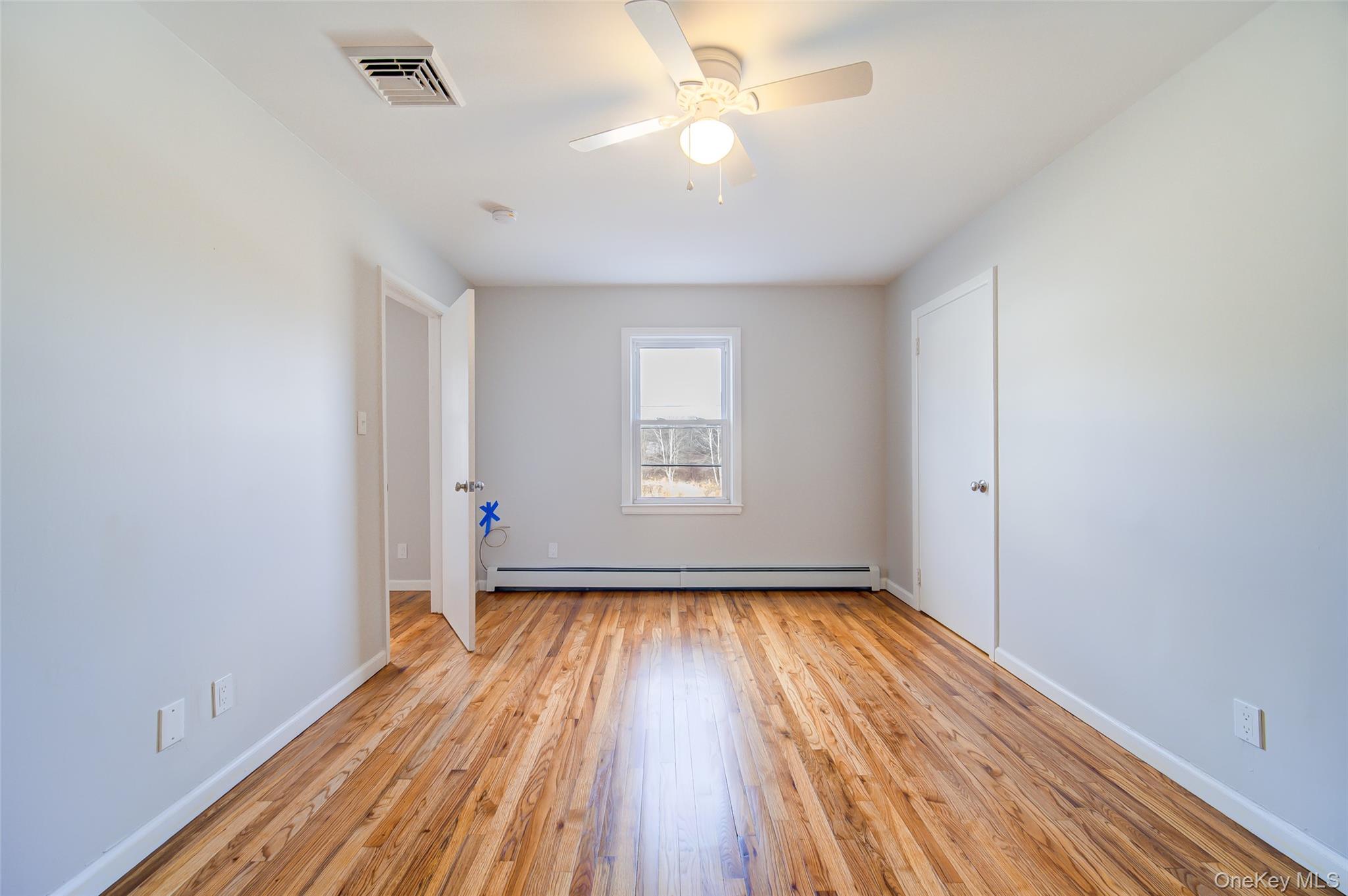 2213 Mt Hope Road, Unit A Middletown, NY 10940 - Photo 10 of 21 wooden floor in an empty room with a window