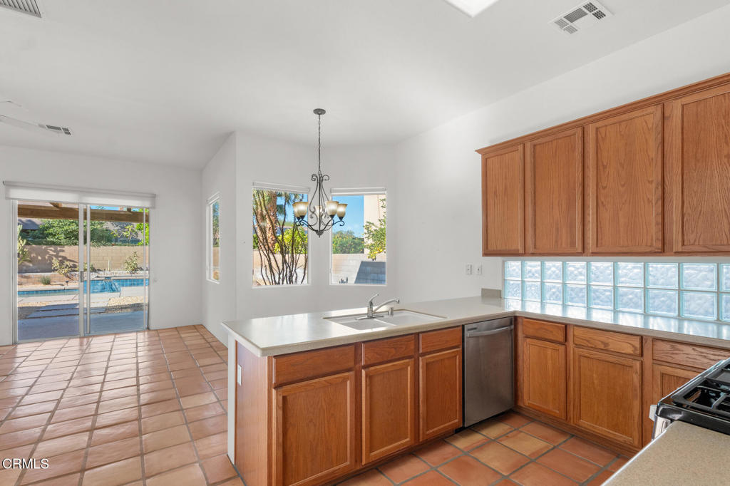 67 Tempe Trail Palm Desert, CA 92211 - Photo 19 of 56 a kitchen with a sink window and cabinets