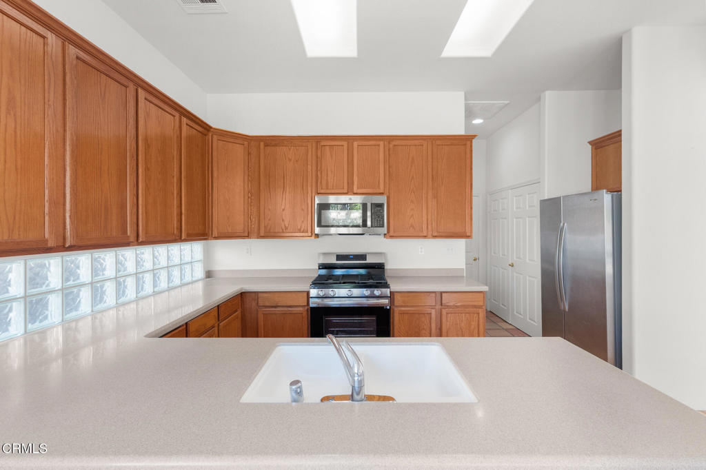 67 Tempe Trail Palm Desert, CA 92211 - Photo 20 of 56 a kitchen with a refrigerator and a sink