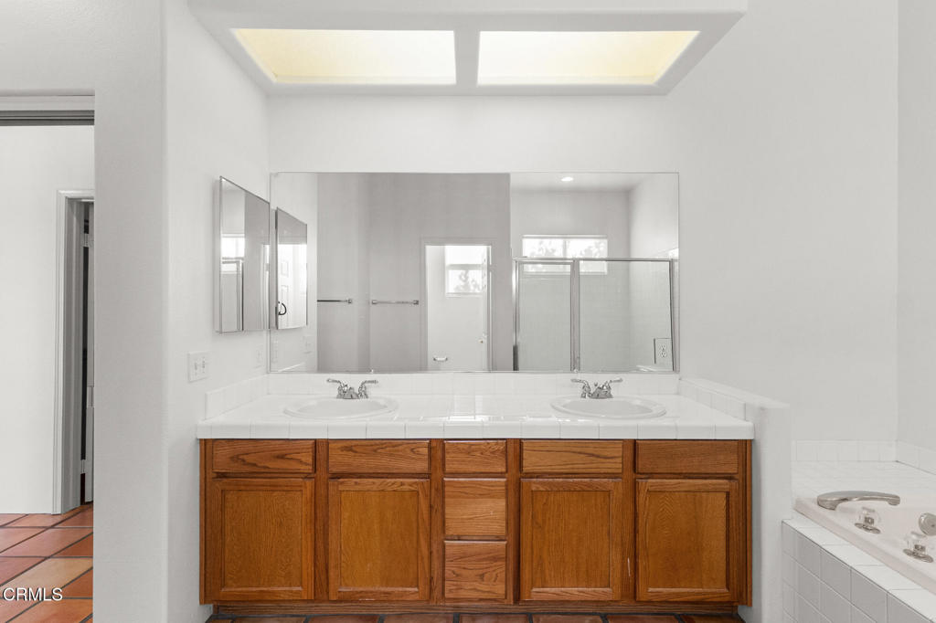 67 Tempe Trail Palm Desert, CA 92211 - Photo 36 of 56 a bathroom with a granite countertop sink mirror and double