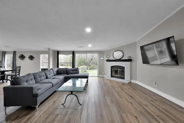 a living room with fireplace furniture and a wooden floor