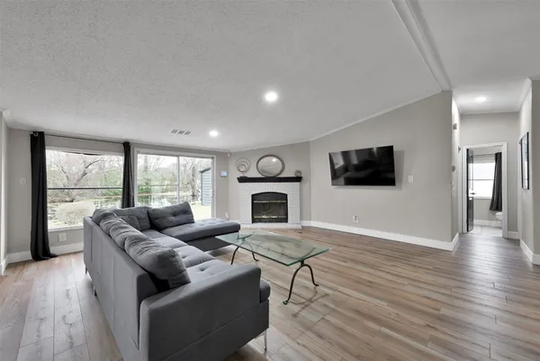 a living room with fireplace furniture and a flat screen tv