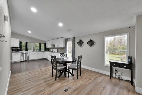 a view of a dining room with furniture and a wooden floor