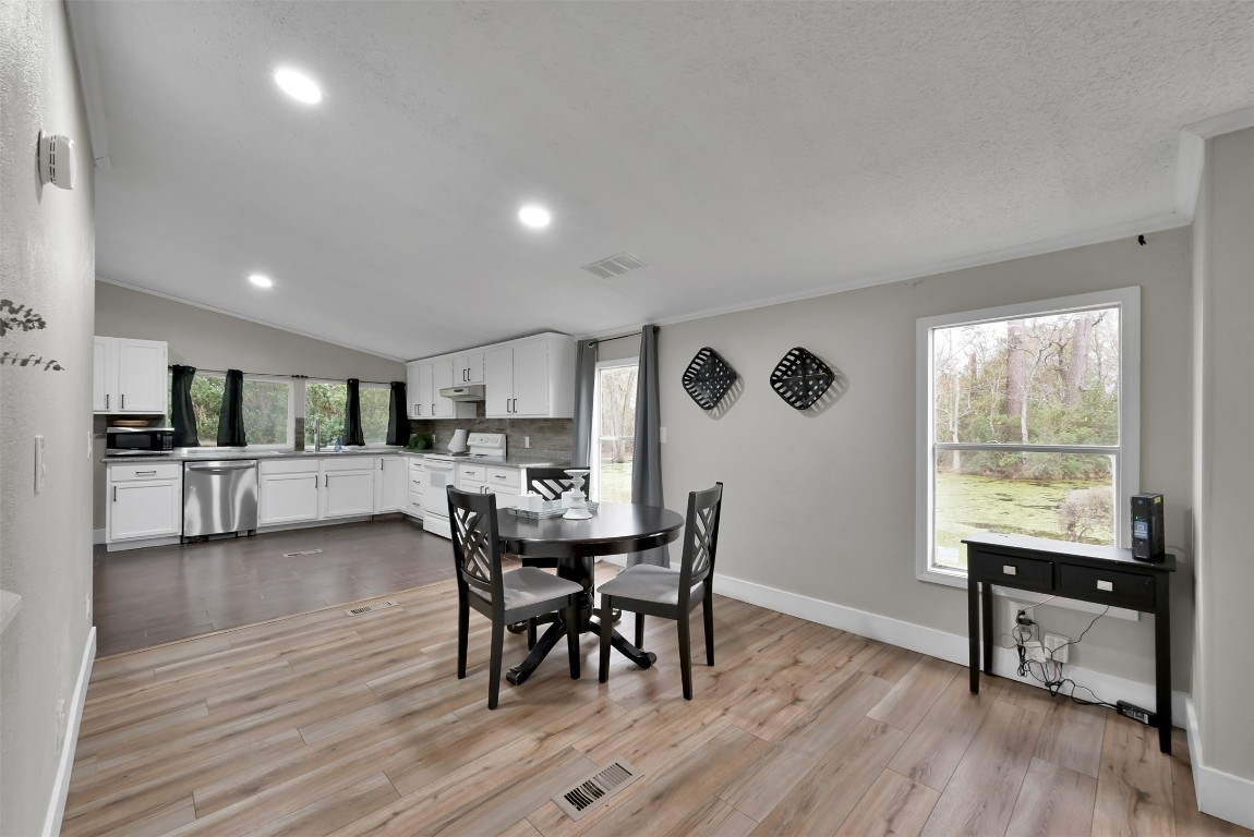 22603 Tuwa Road Tomball, TX 77375 - Photo 15 of 39 a view of a dining room with furniture and a wooden floor