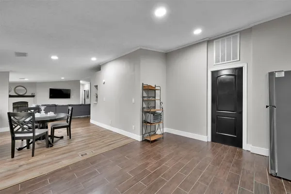 an empty room with wooden floor furniture and windows