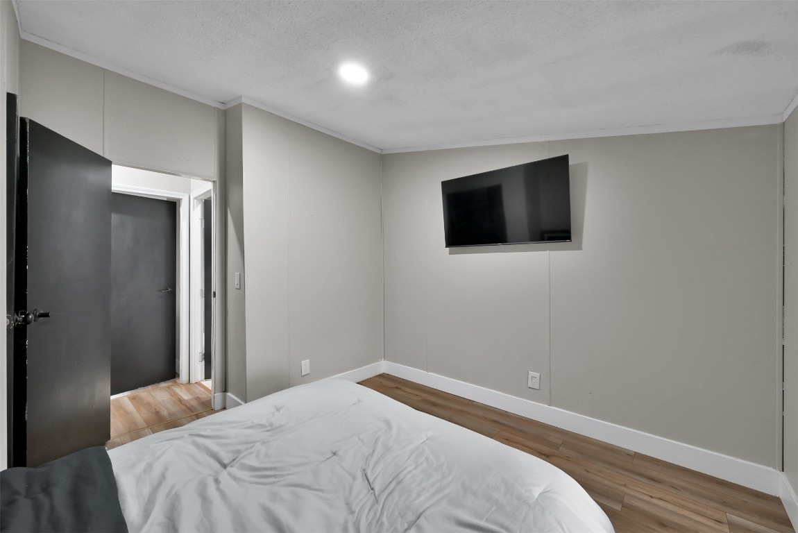 22603 Tuwa Road Tomball, TX 77375 - Photo 21 of 39 a bedroom with a bed and a flat screen tv