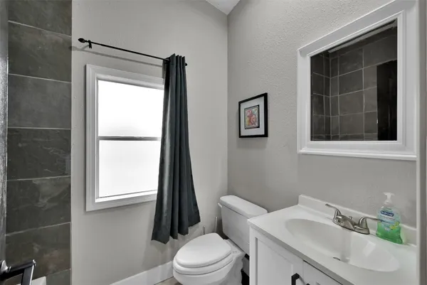 a white toilet sitting next to a bathroom sink
