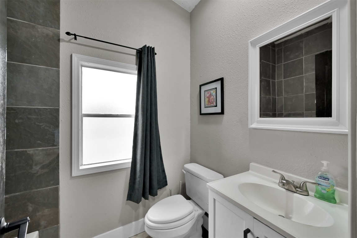 22603 Tuwa Road Tomball, TX 77375 - Photo 22 of 39 a white toilet sitting next to a bathroom sink