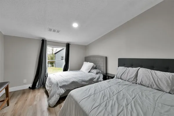 a bedroom with two beds and a window