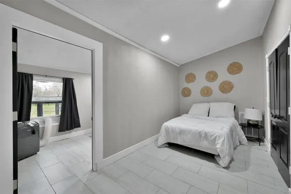 a bedroom with a bed and a mirror