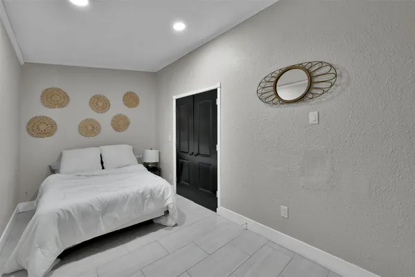 a bedroom with a bed and cabinets