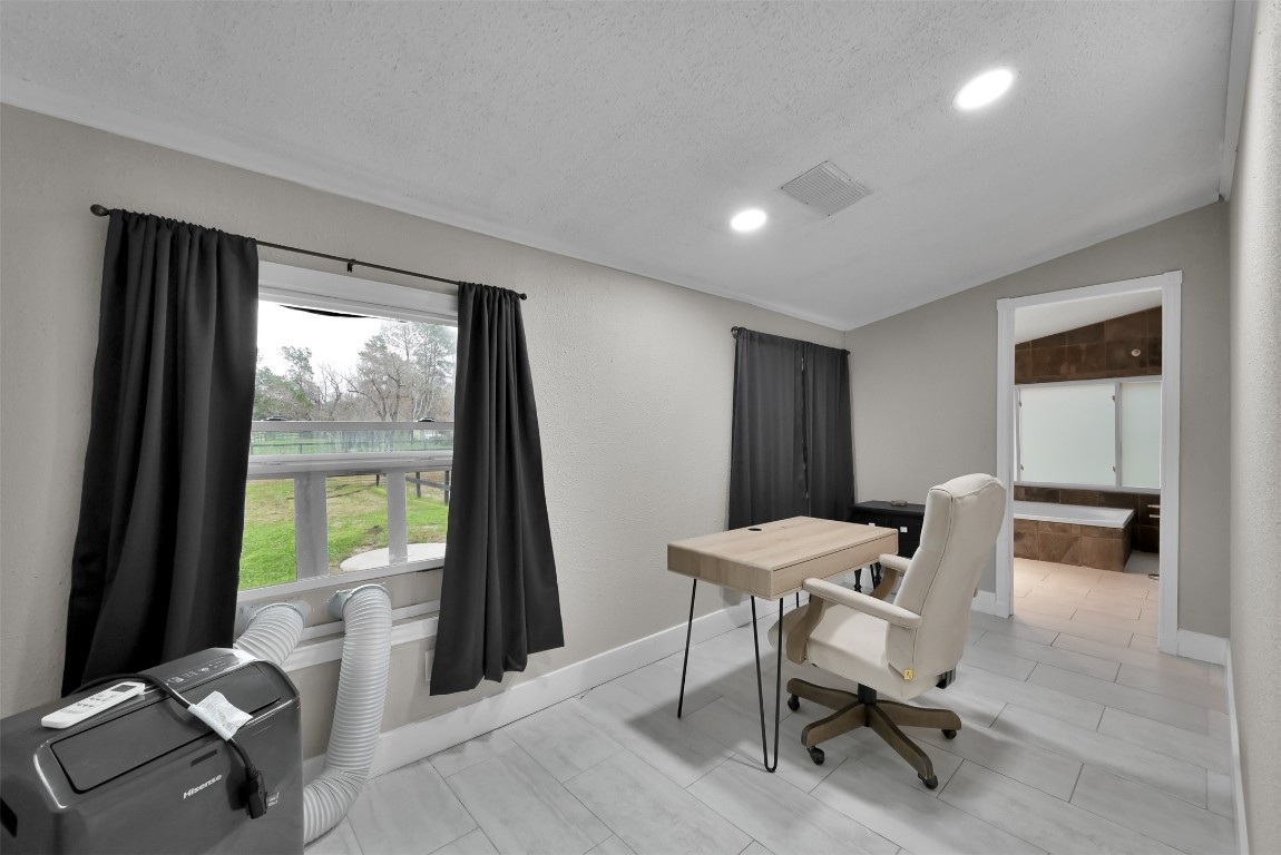 22603 Tuwa Road Tomball, TX 77375 - Photo 29 of 39 a view of a workspace with furniture and a window