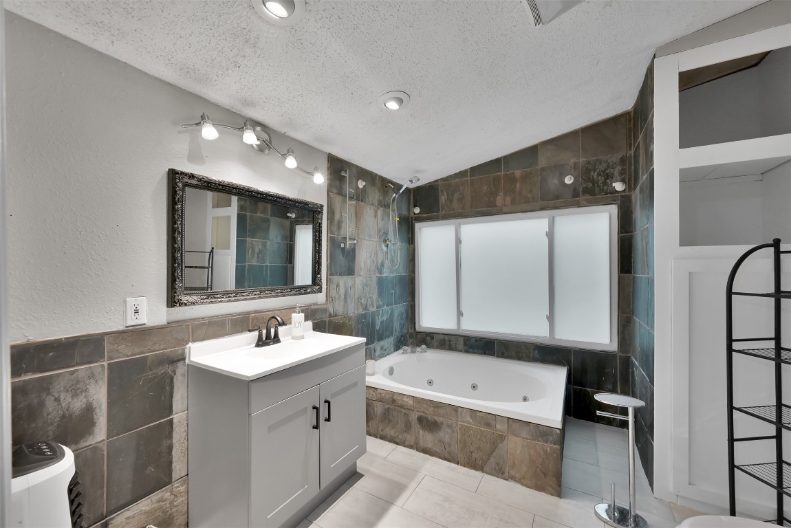 22603 Tuwa Road Tomball, TX 77375 - Photo 30 of 39 a bathroom with a tub sink and mirror