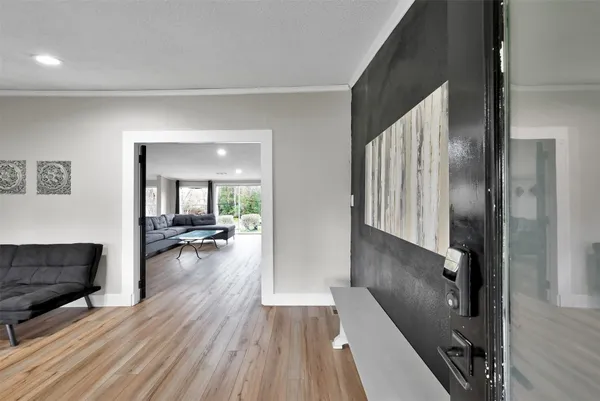 a view of a living room and dining room with wooden floor
