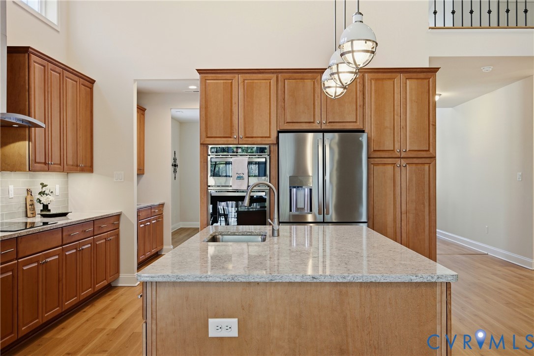 6101 Courage Trail Chester, VA 23831 - Photo 17 of 50 a kitchen with kitchen island granite countertop cabinets and refrigerator