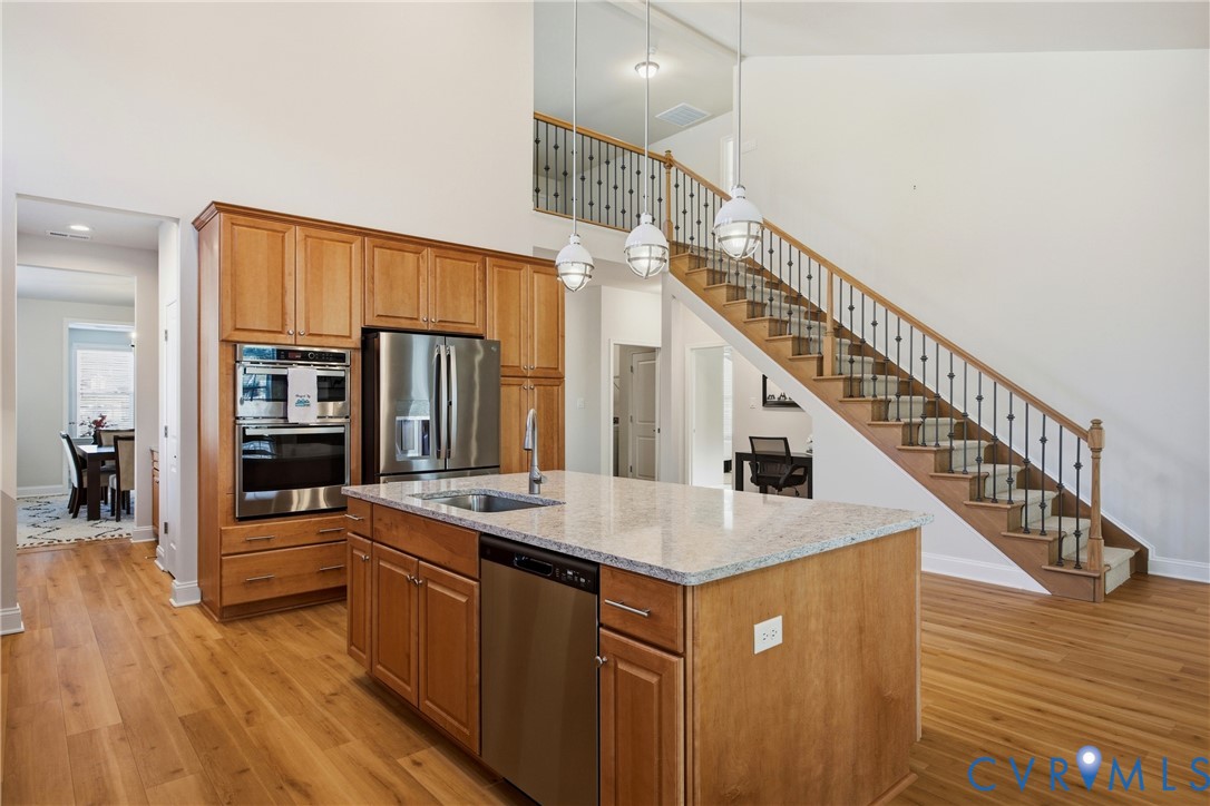 6101 Courage Trail Chester, VA 23831 - Photo 19 of 50 a kitchen with stainless steel appliances granite countertop a kitchen island a stove and a wooden floors