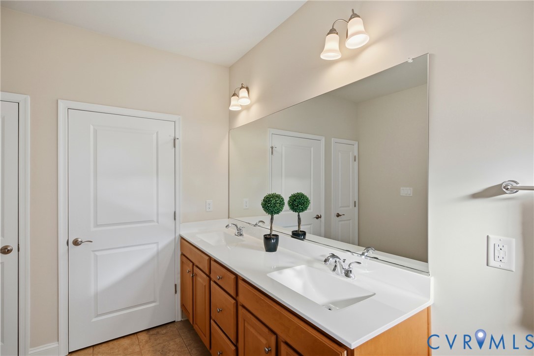 6101 Courage Trail Chester, VA 23831 - Photo 25 of 50 a bathroom with a sink vanity and a mirror