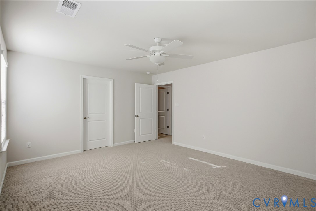 6101 Courage Trail Chester, VA 23831 - Photo 35 of 50 an empty room with a ceiling fan and a window