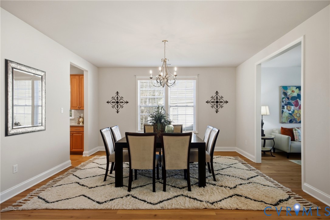 6101 Courage Trail Chester, VA 23831 - Photo 8 of 50 a view of a dining room with furniture and chandelier