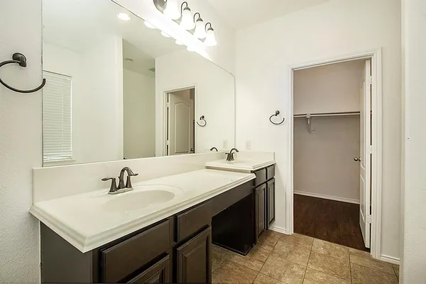 a bathroom with a sink vanity and a mirror