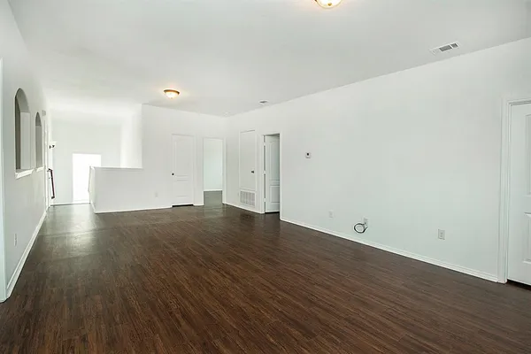 a view of a room with wooden floor and window