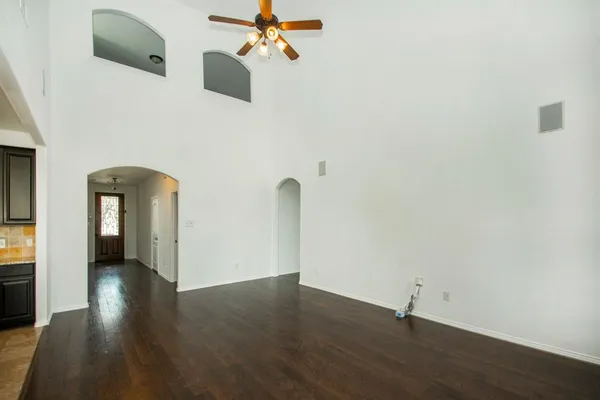 a view of empty room with wooden floor