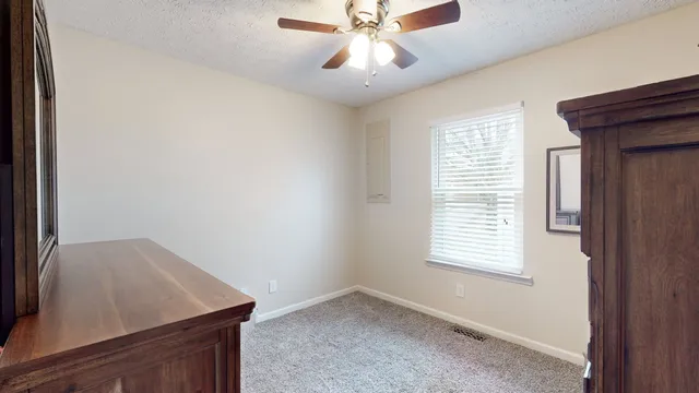 a view of room with window and ceiling fan