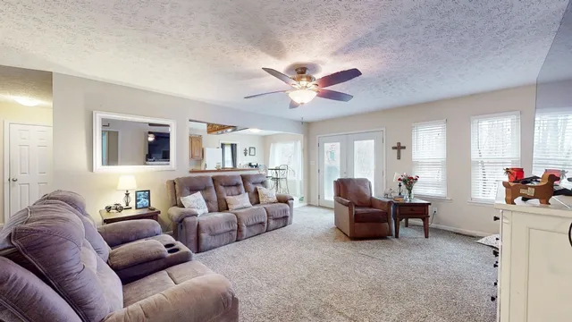 a living room with furniture and a chandelier