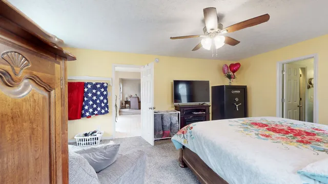 a bedroom with a bed and a chandelier