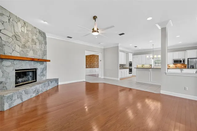a view of a kitchen with kitchen island a island wooden floor and a counter top space
