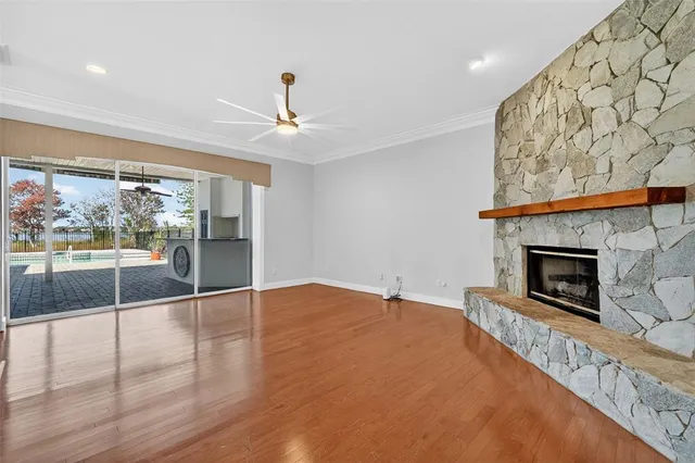 a kitchen with granite countertop a stove a oven a sink dishwasher and cabinets with wooden floor