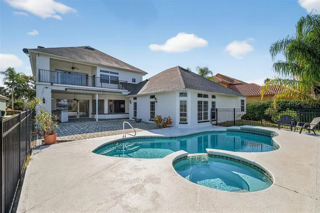 a view of a house with swimming pool and a yard
