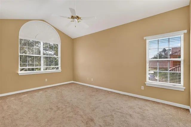 a view of a swimming pool with a yard and plants
