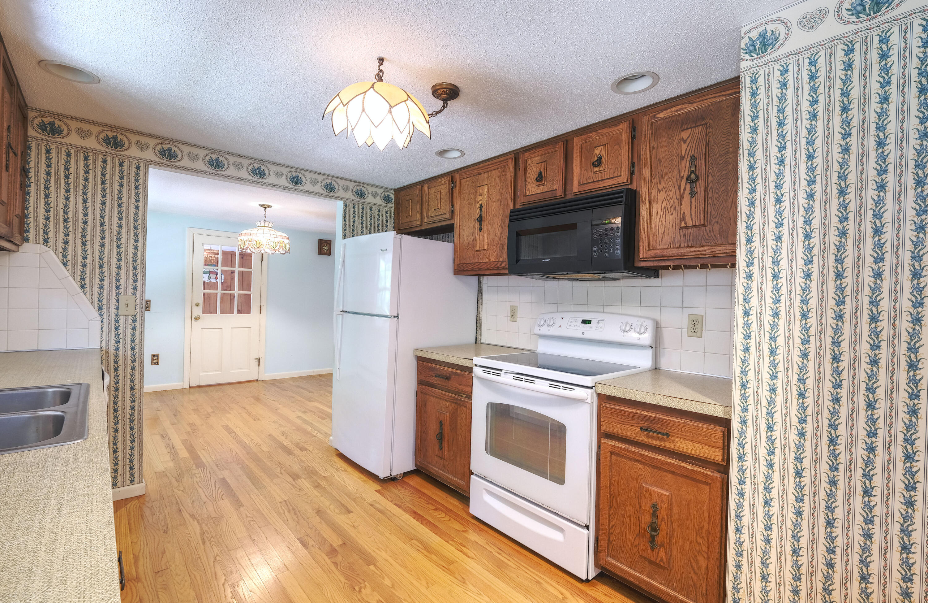 175 Knotty Pine Lane Centerville, MA 02632 - Photo 18 of 60 a kitchen with stainless steel appliances a stove a refrigerator and a microwave