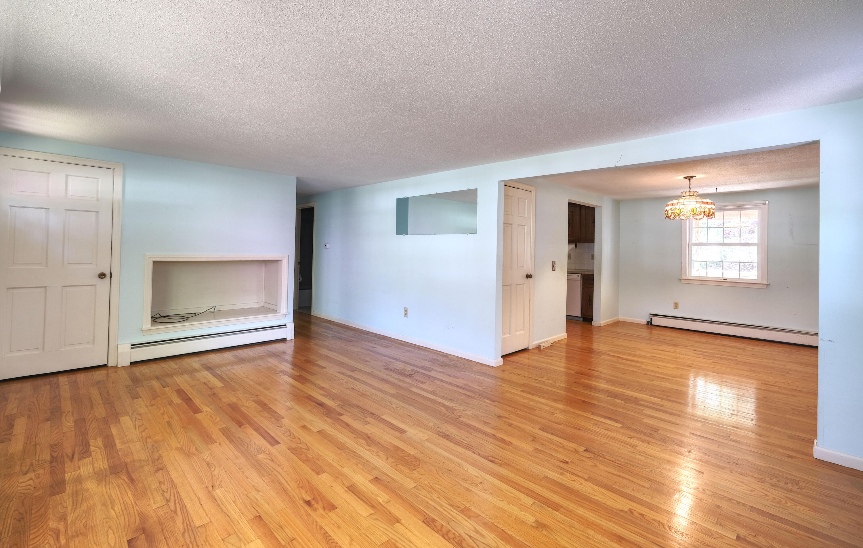 175 Knotty Pine Lane Centerville, MA 02632 - Photo 19 of 60 an empty room with wooden floor and windows