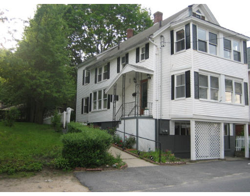 109 Grove Street Clinton, MA 01510 - Photo 2 of 6 a front view of a house with a garden